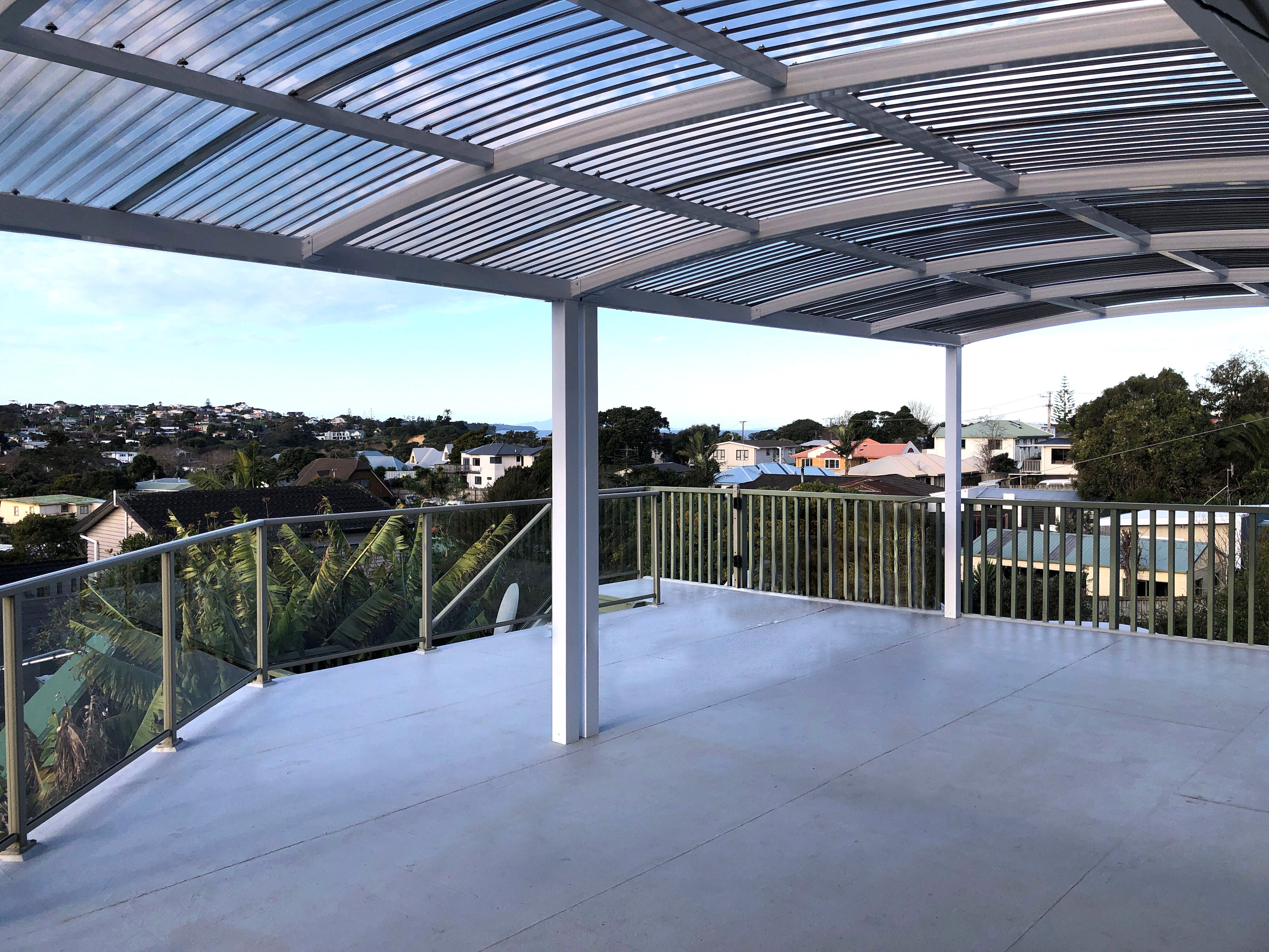 Outdoor entertaining area under a dark-framed pergola